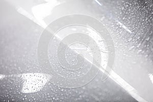 Water droplets on white car paintwork