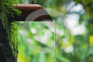 Water dropping from orange pipe