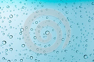 Water drops background. Water drops on glass window over blue sk