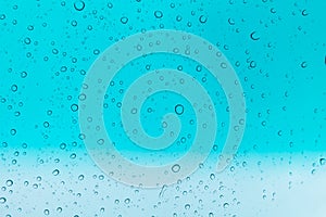 Water drops background. Water drops on glass window over blue sk