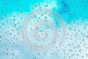 Water drops background. Water drops on glass window over blue sk