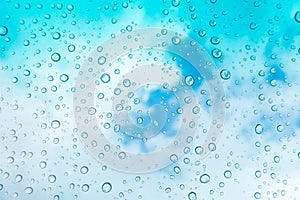 Water drops background. Water drops on glass window over blue sk