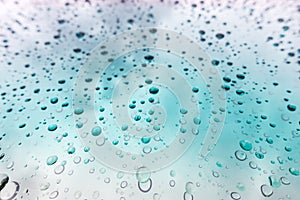 Water drops background. Water drops on glass window over blue sk