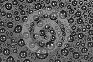 Water drops on black background texture. Dark backdrop glass covered with drops of water. gray bubbles in water