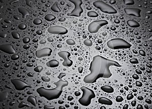 Water drops on black surface.