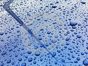 Water drops at blue car paint. Polishing and detailing cars