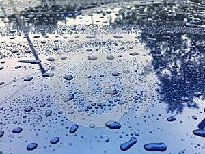 Water drops at blue car paint. Polishing and detailing cars