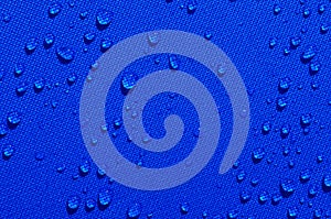 Water drops on blue fabric