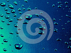 Water drops on blue steel background