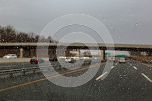 Water drops on the car glass. Car window covered with rain droplets, rainy weather during spring season. Raindrop on the car glass