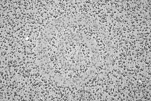 Water drops on car surface in black and white