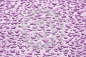 Water drops on car surface in purple tone
