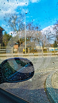 Water drops on a car windshield in sunny day.