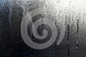 Water drops and condensation in a window glass