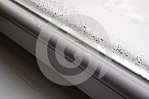 Water drops condensed at cold window during winter season, closeup detail