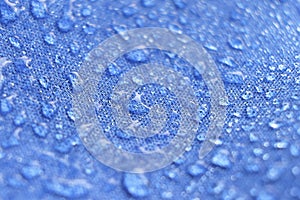 Water drops on the fabric. Rain Water droplets on blue fiber waterproof fabric. Water drops pattern over a waterproof