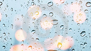 Water drops on glass window with bokeh lights