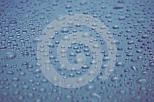 Water drops on grey blue steel background texture