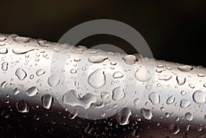 Water drops on metal tube