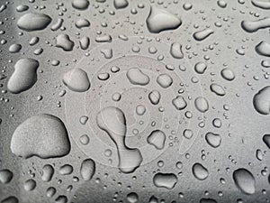 Water drops on metallic silver background closeup