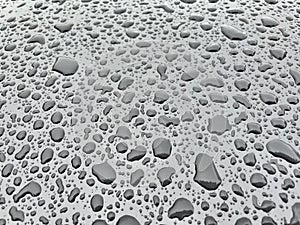 Water drops in metallic surface. Water droplet on the car hood. After rain texture.