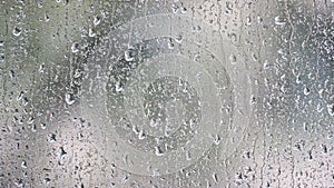 Water drops moving down on window.