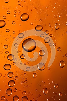 Water drops on orange background. Abstract background of water droplets.