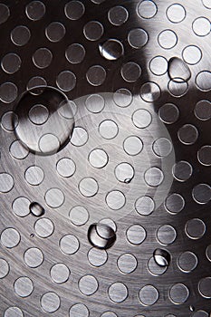 Water drops on the original unusual metal surface close up