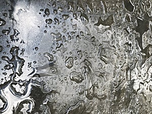 Water drops from the rain on the gray surface of the table