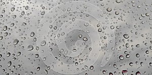 Water drops of rain on the window background look fresh and cool.