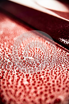 Water drops on red car body. Hydrophobic
