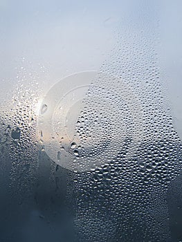 Water drops and sunlight on window glass