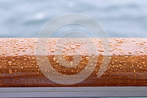 Water drops on a timber handrail