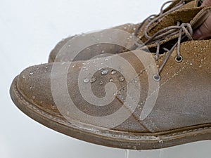 Water drops on waterproof suede desert boots shoes after use weatherproof spray, apparel care equipment photo