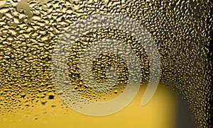 Water drops on the wet glass. Abstract background. Yellow color