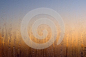 Water drops on a window, on a cold winter morning