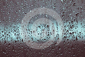 Water drops on window, rain droplets texture on glass surface, cold winter weather, rainy hurricane season