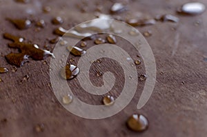 Water drops on wooden texture.