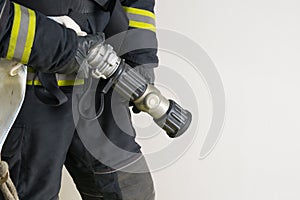 Water equipment for extinguishing  a fire in the hands of a firefighter, close-up