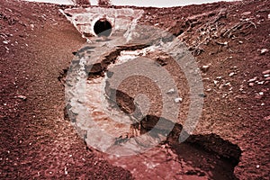 Water erosion by water flow in a chanel or ditch photo