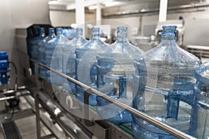 Water factory. Plastic bottle or gallon after washing and cleaning on automated conveyor line