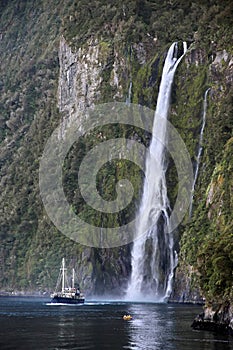 Water fall and boat in the Milford Sound