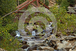 Water fall cascading down a mountain in late afternoon sunlight