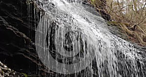 Water falling from the Bridal Veil Falls in a forest on a cloudy day in Heber Springs