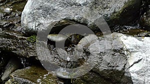 Water falling down man made waterfall in a garden