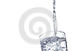 Water falling in glass on isolate background