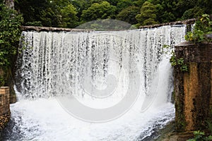 Water falling from old power plant dam in New Athos