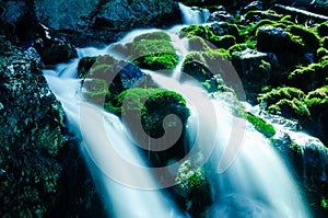 Water Falling Over Mossy Rocks