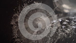 Water falling and splashing creating bubbles and waves on black background. photo