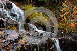 Water falls by highway 155 in Quebec province during autumn time